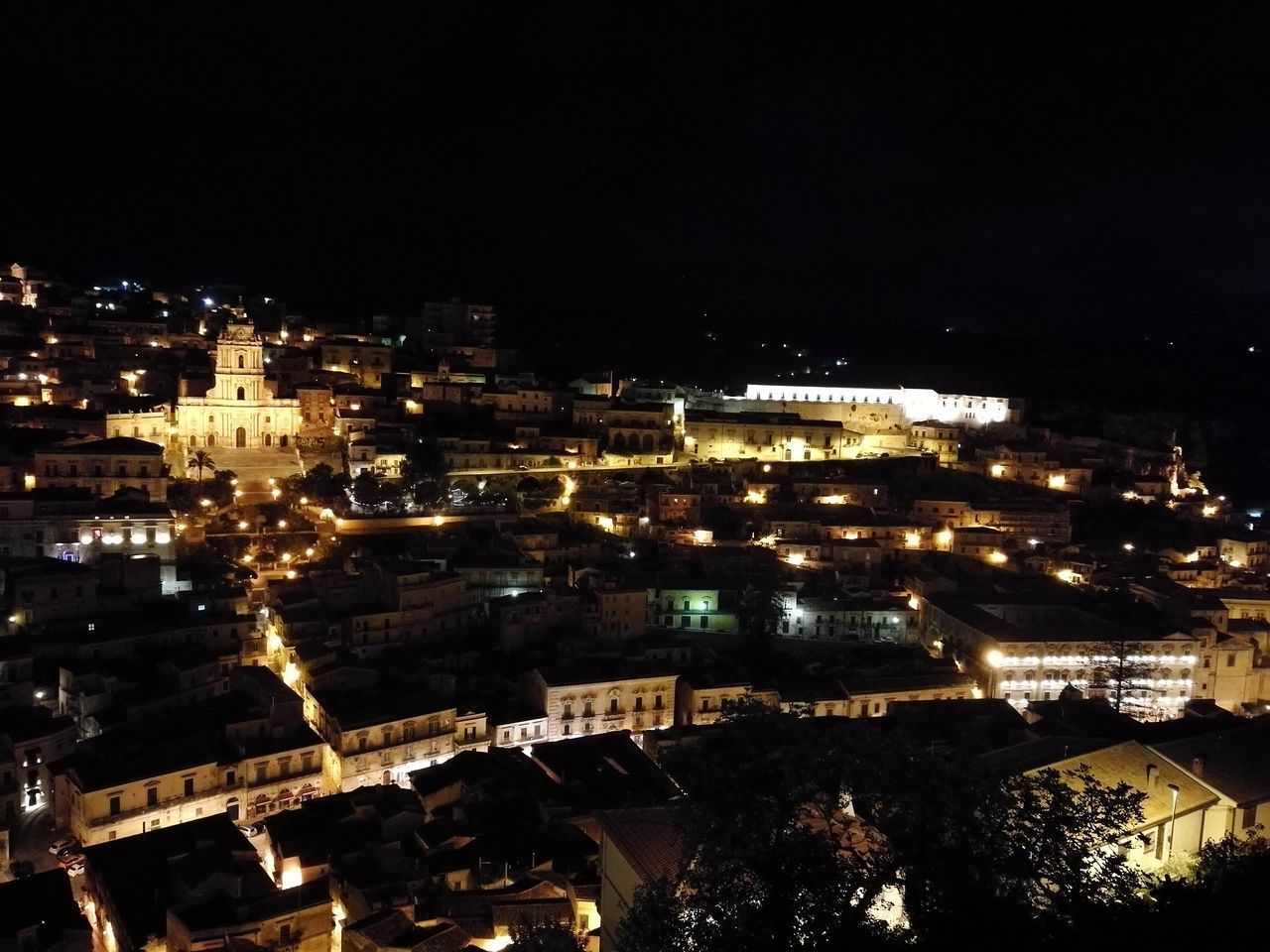 ILLUMINATED CITYSCAPE AGAINST SKY