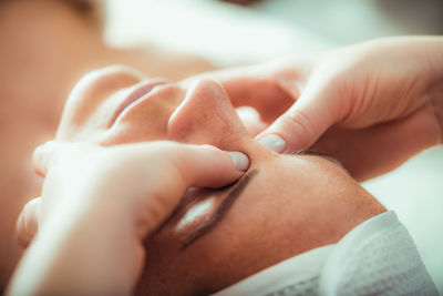 Face lifting massage, beautiful woman getting face lifting massage in a beauty salon.