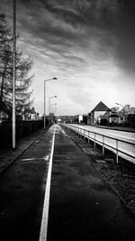 Road by city against sky