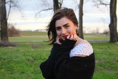 Portrait of smiling young woman on field