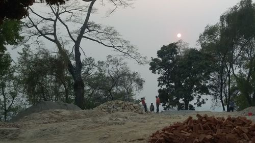 People standing on landscape against sky