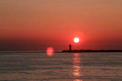 Scenic view of sea against orange sky during sunset