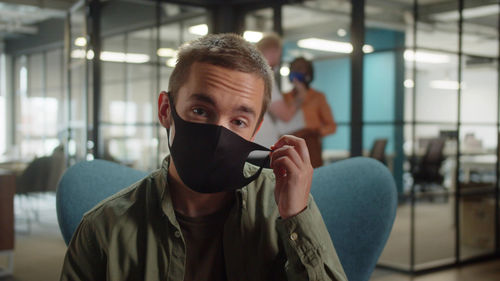 Portrait of businessman wearing mask at office