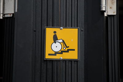 Disabled sign on black wall