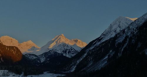 Scenic view of snowcapped mountains against clear sky