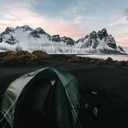 Scenic view of snowcapped mountains against sky during sunset