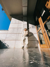 Low angle view of woman standing in puddle