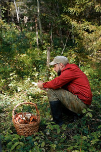 Side view of a man holding basket