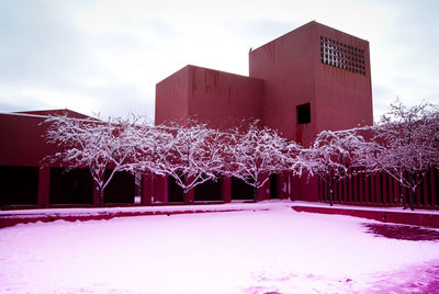 Snow covered built structure against sky