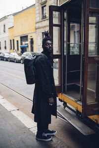 Side view of man standing in city