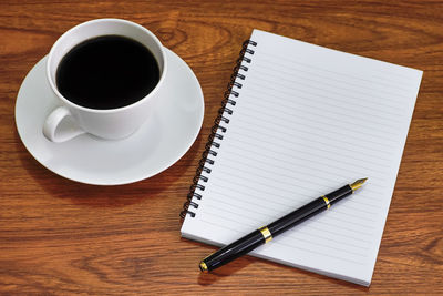 Directly above shot of coffee on wooden table