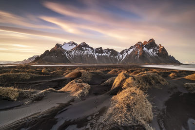 Scenic view of snowcapped mountains against sky during sunset