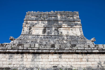 Low angle view of old building against blue sky