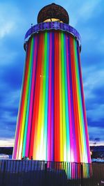 Low angle view of colorful balloons against blue sky
