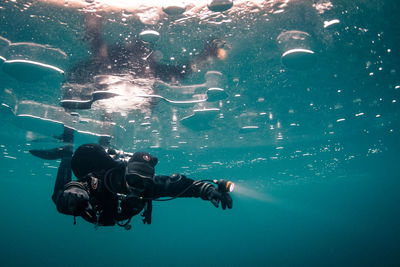 High angle view of man swimming underwater