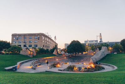 Fountain in park against clear sky