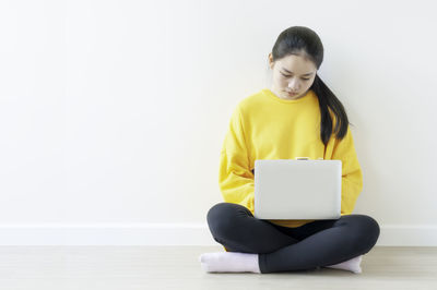 Mid adult woman using mobile phone