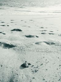 High angle view of footprints on beach