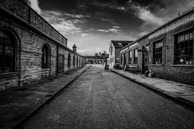 Street amidst buildings in city against sky