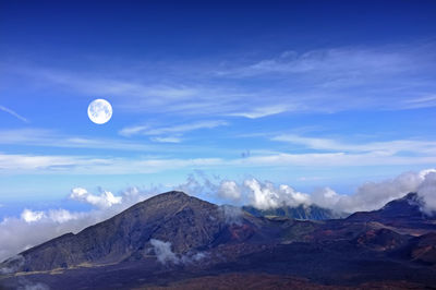 Scenic view of mountains against blue sky