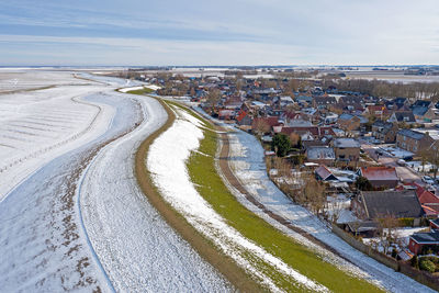 Aerial from snowy village moddergat in friesland in the netherlands in winter