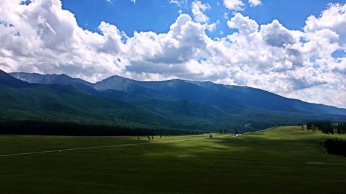 Scenic view of golf course against sky