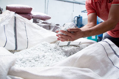 Cropped hand of man holding textile