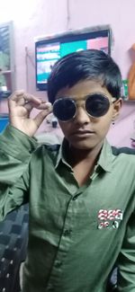 Portrait of boy wearing sunglasses standing outdoors