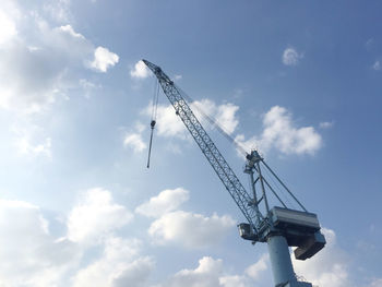 Low angle view of crane against sky