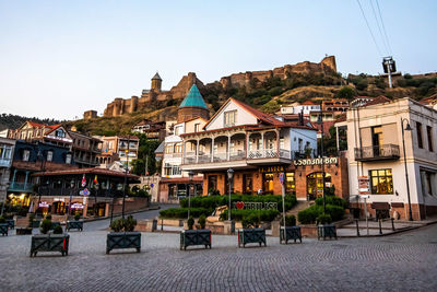 Buildings in town against clear blue sky