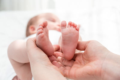 Cropped hand of baby holding hands