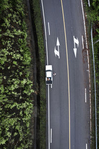 High angle view of text on road against trees