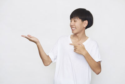 Mid adult man standing against white background