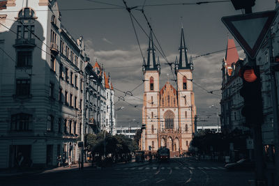 Street amidst buildings against sky in city