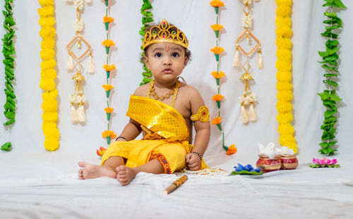 Adorable infant dressed as hindu god krishna on the occasion of janmashtami celebrated at india