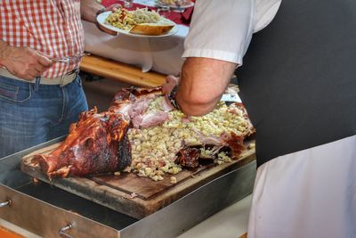 Midsection of man preparing food