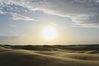 Scenic view of desert against sky during sunset