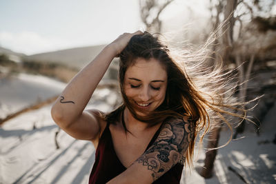 Young woman with arms raised