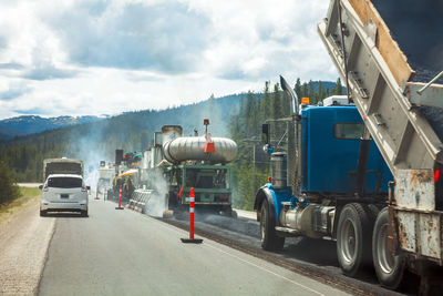 Vehicles on road against sky