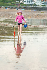 Full length of woman standing on beach