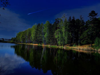 Scenic view of lake against sky at night