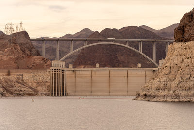 Bridge over river against sky during sunset