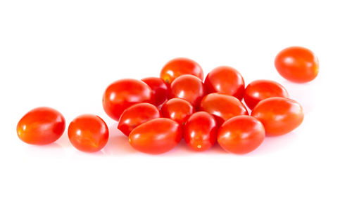 Close-up of tomatoes over white background