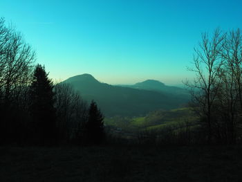 Scenic view of mountains against clear blue sky