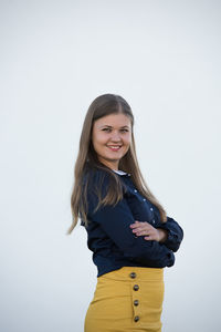 Portrait of a smiling young woman against white background