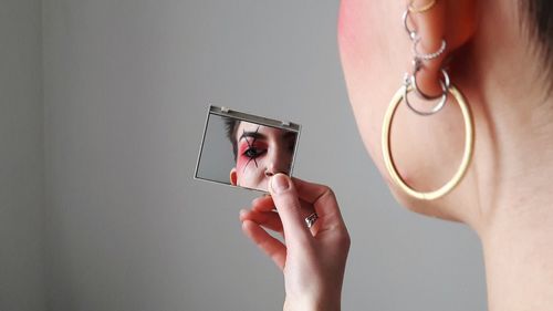 Midsection of woman holding camera