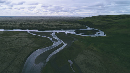 Aerial view of land and sea against sky