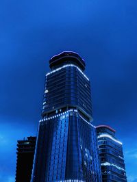 Low angle view of illuminated building against blue sky