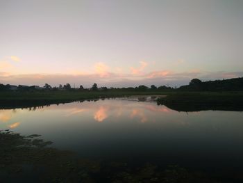 Scenic view of calm lake at sunset