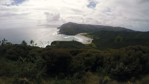 Scenic view of sea and mountains against sky